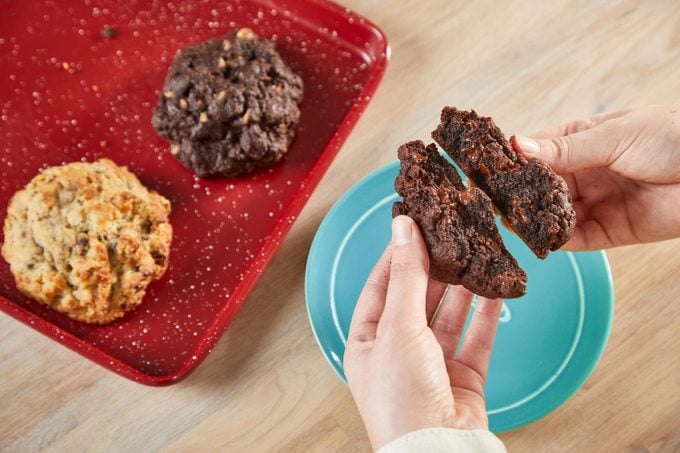 breaking open a cookie during cookie baskets product testing