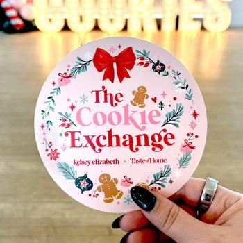 Close-up of a hand holding a tag that reads 'The Cookie Exchange'